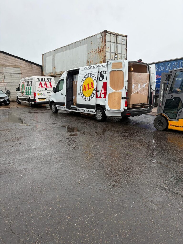 AAA Vans same-day courier van loading retail pallet stock by shipping containers