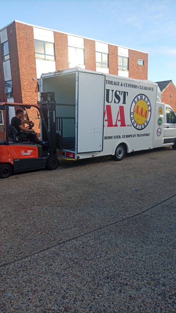 Forklift loading steelwork onto an AAA Vans trailer for same-day sign manufacturing delivery